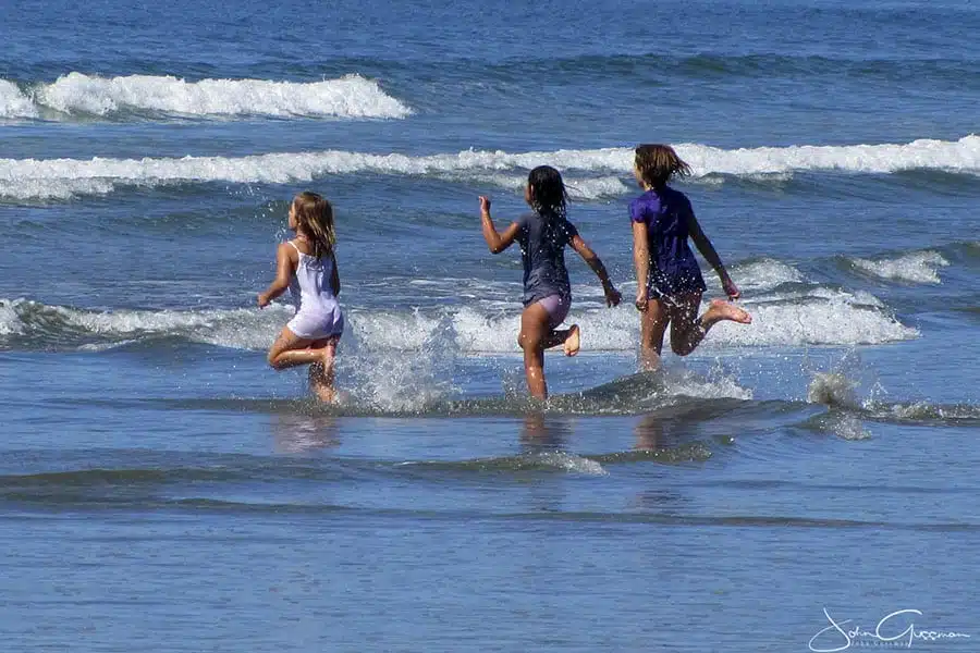 Kids running into water
